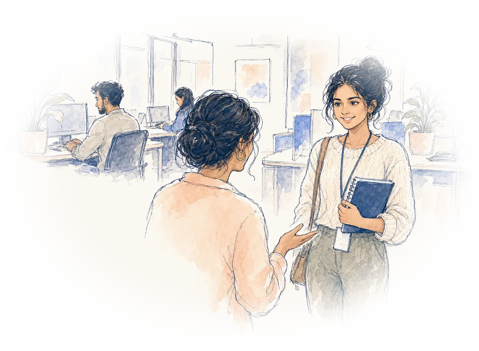 A young woman with a new lanyard is welcomed into a bright office on her first day.